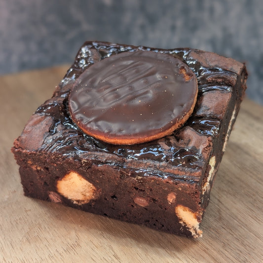 Dark chocolate brownie with jaffa cake pieces and marmalade topping