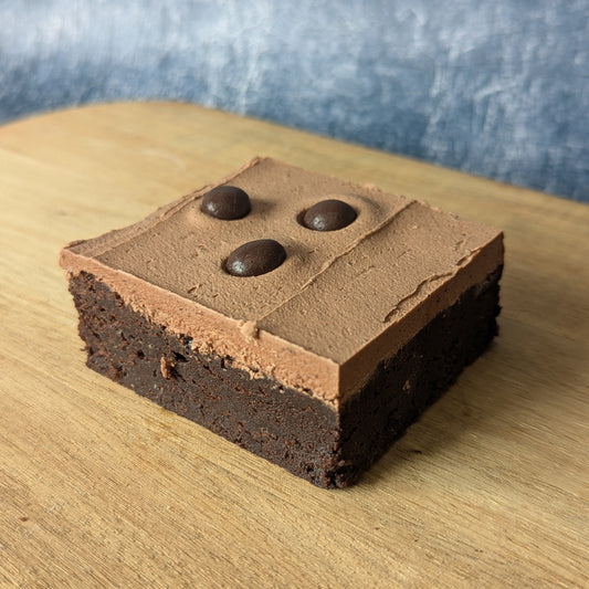 Chocolate and Coffee Brownie Blend with a Mocha Buttercream topping with chocolate covered coffee beans 