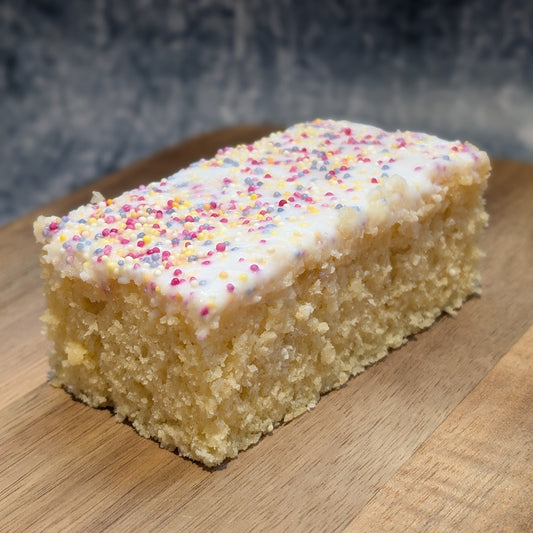Vanilla spong cake with icing and sprinkles