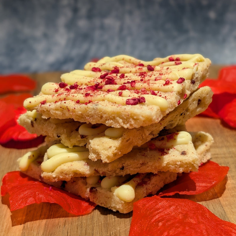 a stack of 4 pieces of white chocolate raspberry flavoured shortbread